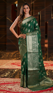 The Handlooms emerald green pure linen Banarasi saree with gold zari border and intricate motifs. Handwoven.