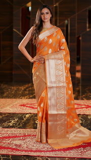The Handlooms orange pure linen Banarasi saree with gold zari border and paisley motifs.