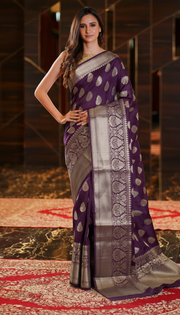 The Handlooms deep purple pure linen Banarasi saree with gold zari border and woven motifs.